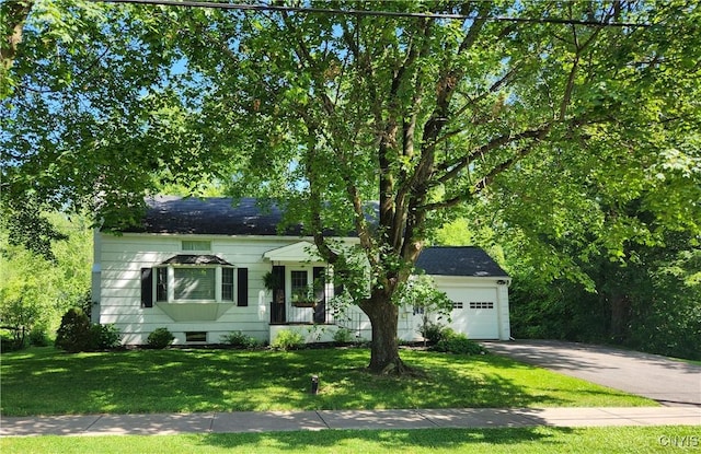 70 W Elizabeth St, Skaneateles, NY 13152 - view of front of home featuring concrete driveway, a front yard, and an attached garage