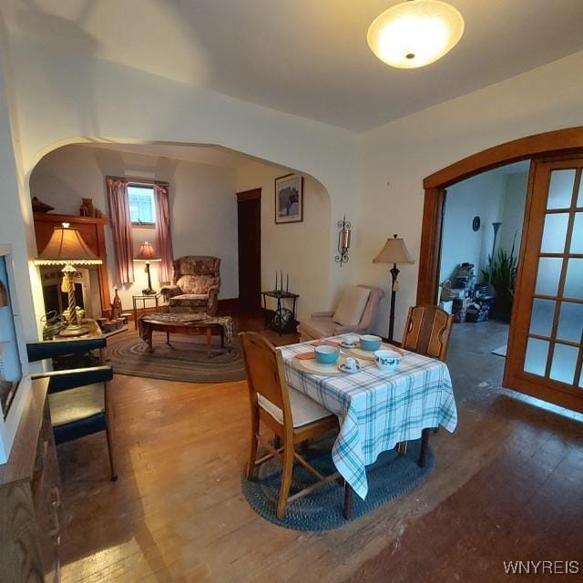 50 Gualbert Ave, Cheektowaga, NY 14211 - dining space featuring arched walkways and wood finished floors