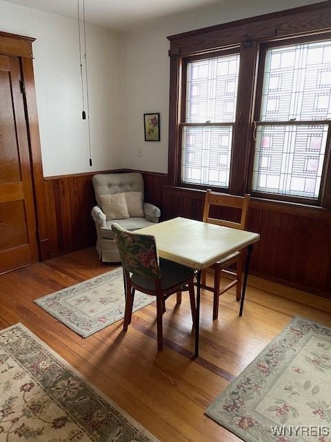 50 Gualbert Ave, Cheektowaga, NY 14211 - dining space featuring a wainscoted wall, light wood-type flooring, and wooden walls