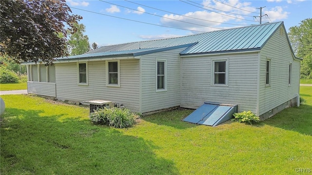 8278 Maple Rd, Clay, NY 13041 - back of house featuring a lawn and metal roof