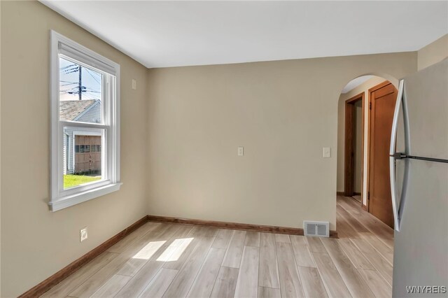 49 Central Blvd, Cheektowaga, NY 14225 - empty room featuring light wood-style flooring, arched walkways, and baseboards