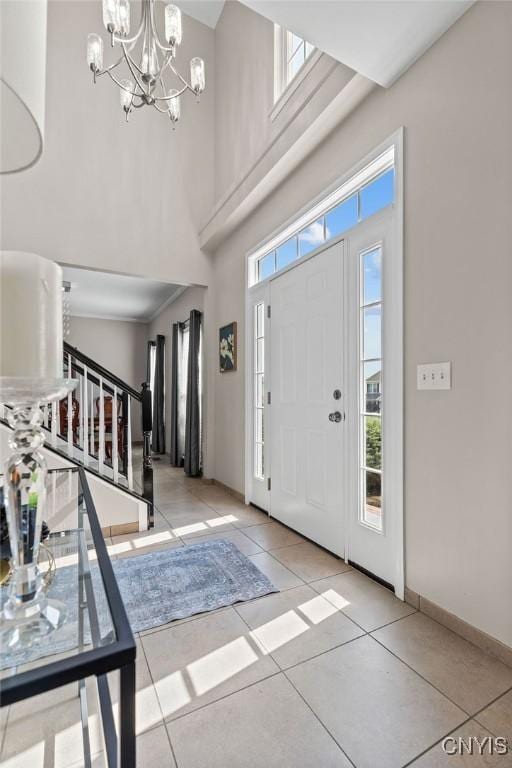 163 Golden Meadows Way, Camillus, NY 13164 - tiled entrance foyer with stairway, a high ceiling, a chandelier, and baseboards