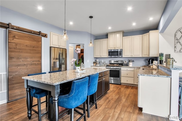 123 Stonebridge Rd, Grand Island, NY 14072 - kitchen with appliances with stainless steel finishes, a sink, a breakfast bar area, light stone countertops, and a kitchen island