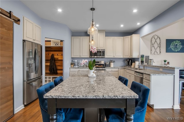 123 Stonebridge Rd, Grand Island, NY 14072 - kitchen featuring stainless steel appliances, dark wood-style flooring, a peninsula, a sink, and a breakfast bar area