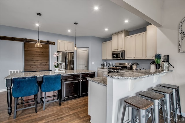 123 Stonebridge Rd, Grand Island, NY 14072 - kitchen with stainless steel appliances, dark wood finished floors, a center island, a kitchen breakfast bar, and light stone countertops