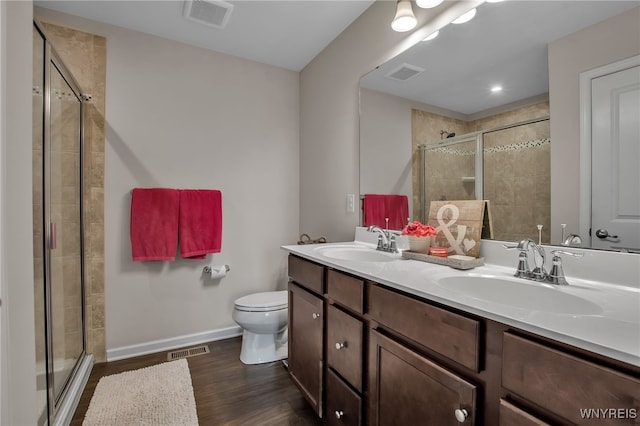 123 Stonebridge Rd, Grand Island, NY 14072 - bathroom with toilet, double vanity, a shower stall, baseboards, and wood finished floors