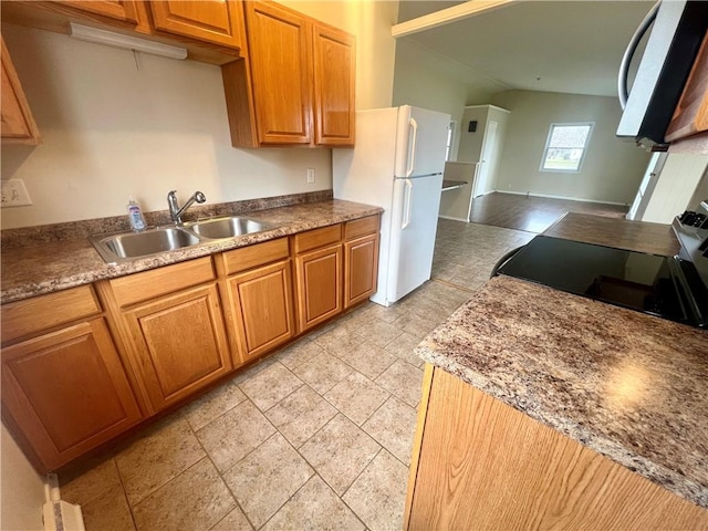 137 Matthew Cir, Horseheads, NY 14845 - kitchen with a sink, range with electric cooktop, freestanding refrigerator, brown cabinets, and lofted ceiling