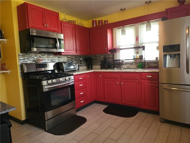 313 Gardner Rd, Horseheads, NY 14845 - kitchen featuring stainless steel appliances, backsplash, light wood finished floors, dark brown cabinets, and a sink