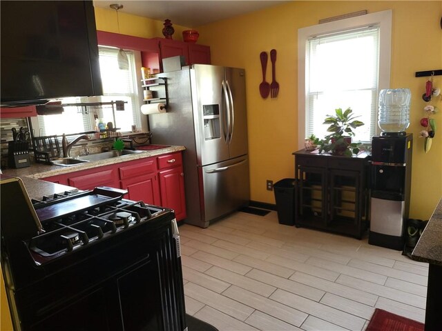 313 Gardner Rd, Horseheads, NY 14845 - kitchen featuring stainless steel refrigerator with ice dispenser, black gas range oven, a sink, dark brown cabinets, and decorative light fixtures