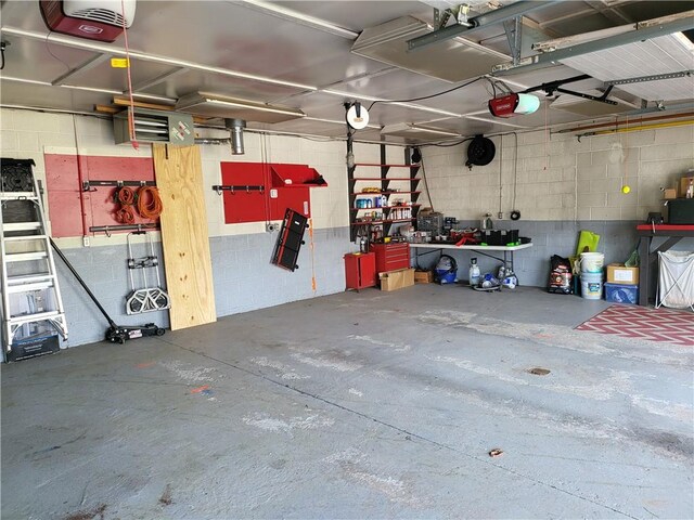 313 Gardner Rd, Horseheads, NY 14845 - garage with a garage door opener, concrete block wall, and a heating unit