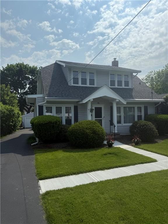 16 Cobbles E, Elmira, NY 14905 - view of front facade featuring a shingled roof, a front lawn, and a chimney