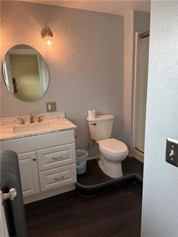16 Cobbles E, Elmira, NY 14905 - full bathroom with wood finished floors, vanity, toilet, a stall shower, and a textured wall