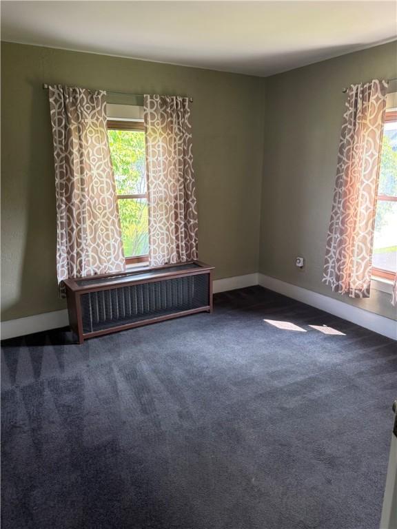 16 Cobbles E, Elmira, NY 14905 - carpeted spare room featuring radiator heating unit and baseboards