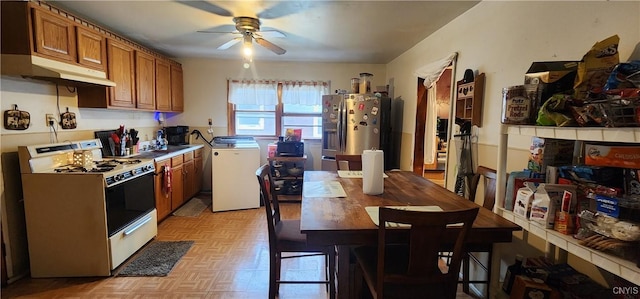 16 Bryant St, Utica, NY 13502 - kitchen featuring white range oven, stainless steel refrigerator with ice dispenser, under cabinet range hood, brown cabinets, and washer / clothes dryer