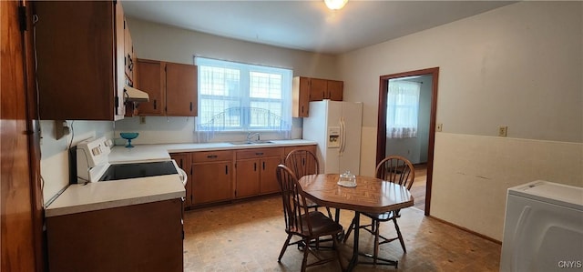 16 Bryant St, Utica, NY 13502 - kitchen with stove, white refrigerator with ice dispenser, a sink, light countertops, and extractor fan