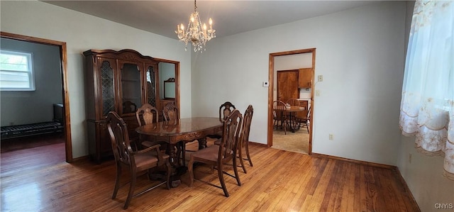 16 Bryant St, Utica, NY 13502 - dining space with a chandelier, light wood finished floors, and baseboards