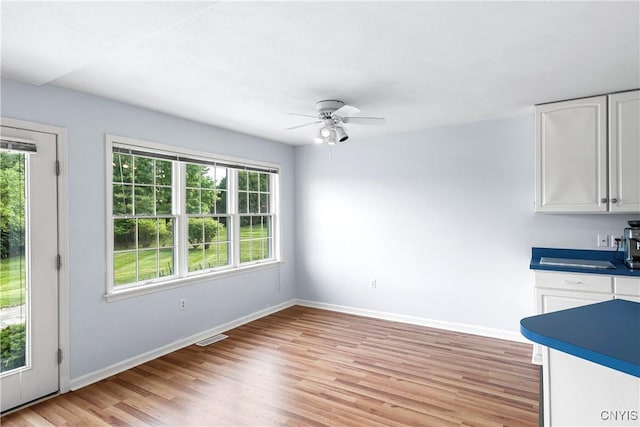 1 Wicklow Dr, Skaneateles, NY 13152 - unfurnished dining area with ceiling fan, light wood-style floors, and baseboards