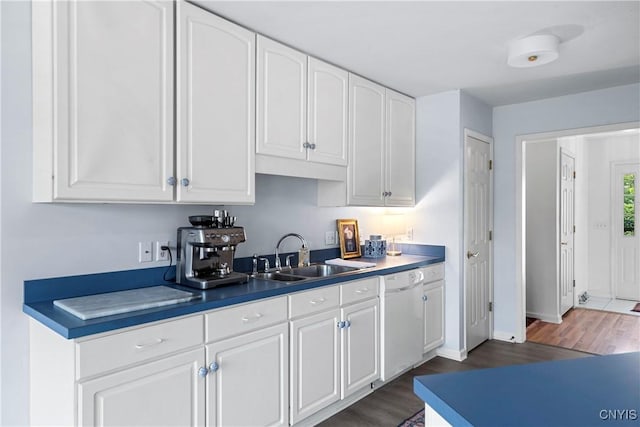 1 Wicklow Dr, Skaneateles, NY 13152 - kitchen featuring dishwasher, a sink, dark wood finished floors, white cabinetry, and baseboards