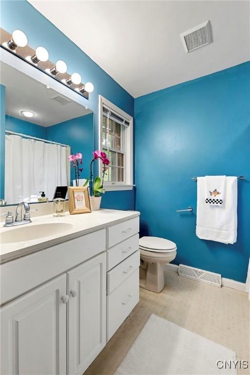 1 Wicklow Dr, Skaneateles, NY 13152 - bathroom with vanity, toilet, and wood finished floors