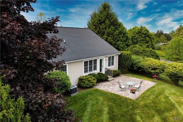 1 Wicklow Dr, Skaneateles, NY 13152 - back of property with a yard, a patio, central AC, and a shingled roof