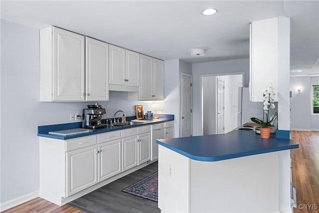 1 Wicklow Dr, Skaneateles, NY 13152 - kitchen with a sink, stainless steel dishwasher, wood finished floors, white cabinetry, and baseboards