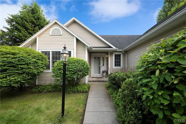 1 Wicklow Dr, Skaneateles, NY 13152 - property entrance with a lawn and a shingled roof