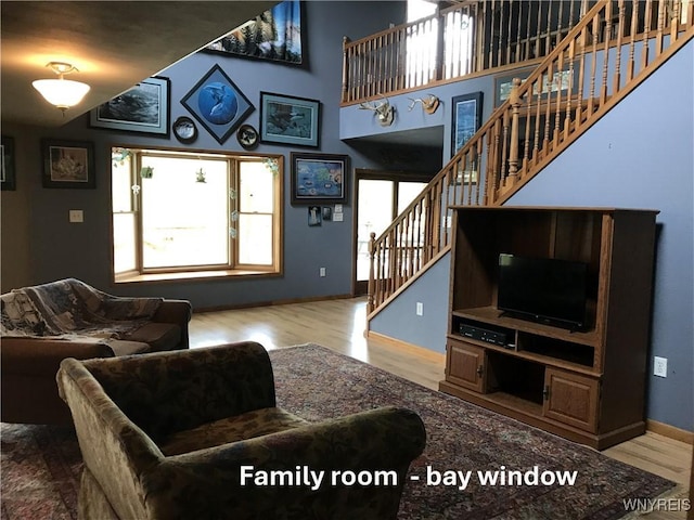 5877 Rte 362, Wethersfield, NY 14024 - living room featuring stairs, plenty of natural light, wood finished floors, and baseboards