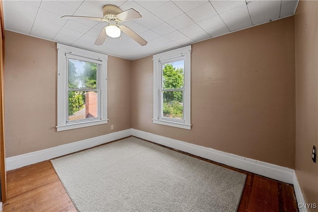 172 Nichols Ave, Syracuse, NY 13206 - empty room featuring wood finished floors, baseboards, plenty of natural light, and a ceiling fan