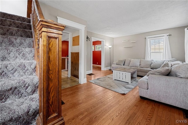 172 Nichols Ave, Syracuse, NY 13206 - living room with hardwood / wood-style flooring, a textured ceiling, and baseboards