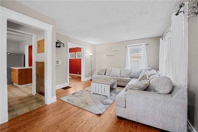 172 Nichols Ave, Syracuse, NY 13206 - living area featuring light wood-style floors, baseboards, and a textured ceiling