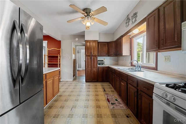 172 Nichols Ave, Syracuse, NY 13206 - kitchen featuring freestanding refrigerator, a sink, light countertops, light floors, and ceiling fan