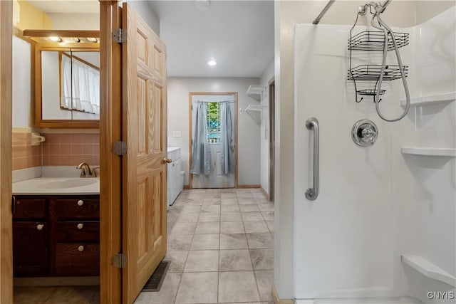 172 Nichols Ave, Syracuse, NY 13206 - bathroom with a shower, vanity, recessed lighting, and washer / clothes dryer