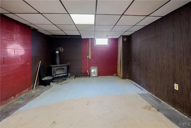 172 Nichols Ave, Syracuse, NY 13206 - basement with a wood stove, a drop ceiling, and concrete block wall