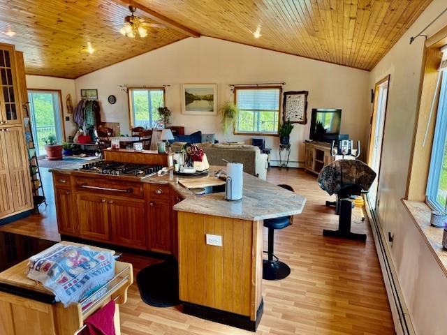 251 Pearsall Rd, Westford, NY 12155 - kitchen with stainless steel gas cooktop, open floor plan, wooden ceiling, vaulted ceiling, and a kitchen island