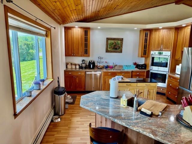 251 Pearsall Rd, Westford, NY 12155 - kitchen with stainless steel appliances, vaulted ceiling, brown cabinetry, wood ceiling, and a sink