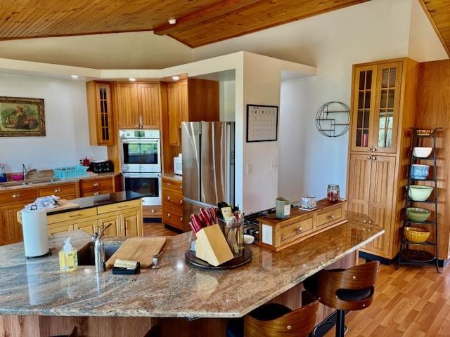 251 Pearsall Rd, Westford, NY 12155 - kitchen featuring appliances with stainless steel finishes, wooden ceiling, a sink, vaulted ceiling, and brown cabinets
