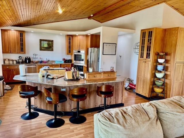 251 Pearsall Rd, Westford, NY 12155 - kitchen with appliances with stainless steel finishes, vaulted ceiling, brown cabinets, glass insert cabinets, and wooden ceiling