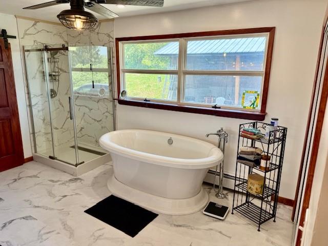 251 Pearsall Rd, Westford, NY 12155 - bathroom featuring a marble finish shower, marble finish flooring, a freestanding tub, ceiling fan, and baseboards