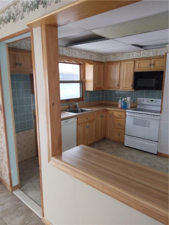 251 Pearsall Rd, Westford, NY 12155 - kitchen featuring white appliances, a sink, wallpapered walls, light countertops, and baseboards