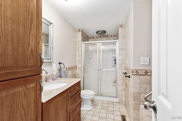 4190 Stepping Stone Ln, Clay, NY 13090 - bathroom with tile walls, tile patterned flooring, vanity, a stall shower, and toilet