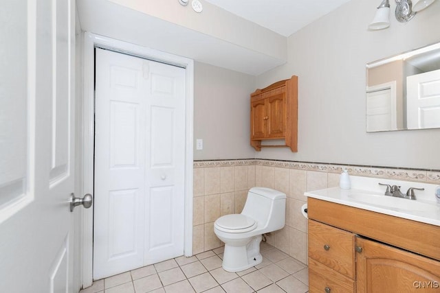 4190 Stepping Stone Ln, Clay, NY 13090 - bathroom with vanity, tile patterned floors, a wainscoted wall, toilet, and tile walls