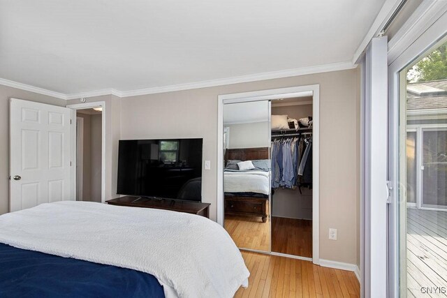 4190 Stepping Stone Ln, Clay, NY 13090 - bedroom with light wood finished floors, crown molding, a walk in closet, baseboards, and a closet