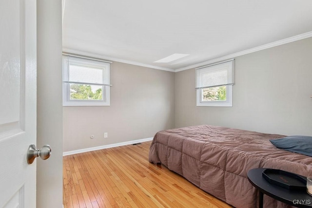 4190 Stepping Stone Ln, Clay, NY 13090 - bedroom with a skylight, light wood-style flooring, crown molding, and baseboards