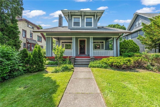 1579 Culver Rd, Rochester, NY 14609 - view of front of home with a front yard, a porch, and a chimney