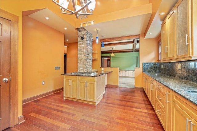 1579 Culver Rd, Rochester, NY 14609 - kitchen with decorative backsplash, light wood-type flooring, baseboards, dark stone counters, and beamed ceiling