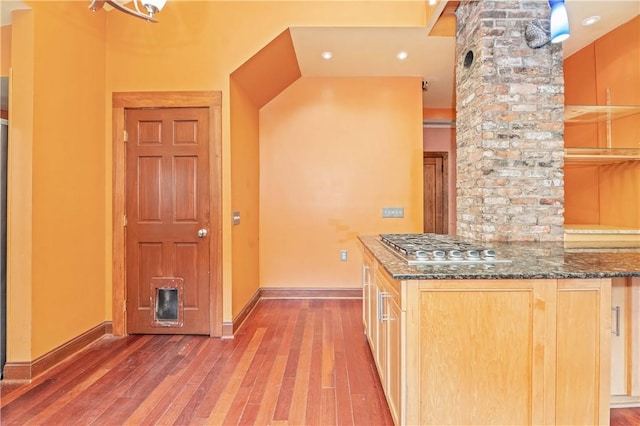 1579 Culver Rd, Rochester, NY 14609 - kitchen with hardwood / wood-style flooring, stainless steel gas cooktop, baseboards, and dark stone counters