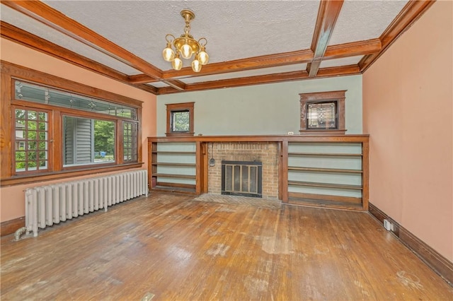 1579 Culver Rd, Rochester, NY 14609 - unfurnished living room with radiator, hardwood / wood-style floors, coffered ceiling, a chandelier, and a brick fireplace