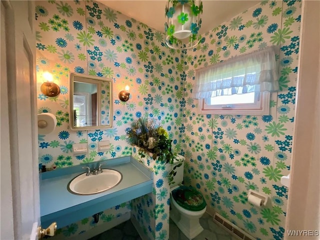 21 Kathy Ln, West Seneca, NY 14224 - bathroom featuring a sink, toilet, and wallpapered walls
