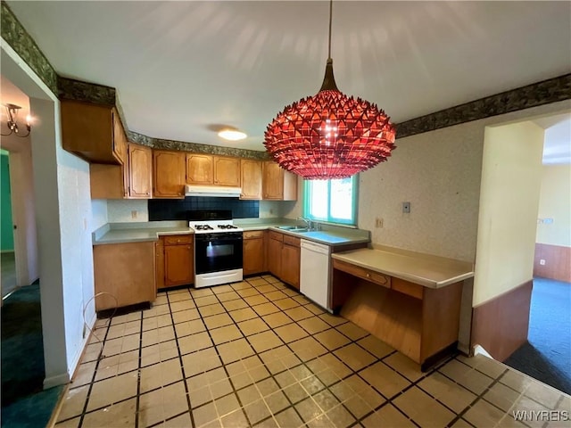 21 Kathy Ln, West Seneca, NY 14224 - kitchen featuring white appliances, under cabinet range hood, a sink, and light countertops