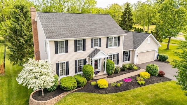 2 Princeton Ln, Perinton, NY 14450 - colonial home featuring a chimney, an attached garage, asphalt driveway, and a front yard